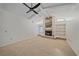 Spacious living room showcasing a fireplace with built-in shelving and a large window for natural light at 1426 Landview Ln, Osprey, FL 34229