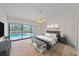 Inviting main bedroom with pool view, en-suite bath, ceiling fan, and neutral decor for a peaceful retreat at 1426 Landview Ln, Osprey, FL 34229