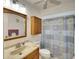 Bathroom with shower, toilet and wood vanity at 1430 57Th W St # 1430, Bradenton, FL 34209