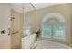 Bathroom featuring a large walk-in shower and a soaking tub at 146 Willow Bend Way, Osprey, FL 34229