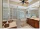 Elegant bathroom with double vanity, soaking tub, and glass block shower at 146 Willow Bend Way, Osprey, FL 34229