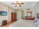 Bedroom with bamboo furniture, flat screen TV, and ceiling fan at 146 Willow Bend Way, Osprey, FL 34229