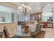 Bright dining room with glass-top table and a view into the kitchen at 146 Willow Bend Way, Osprey, FL 34229