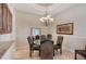 Elegant dining room with glass table, chandelier and leather chairs at 146 Willow Bend Way, Osprey, FL 34229