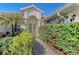 Front entry with walkway, lush landscaping, and a decorative fountain at 146 Willow Bend Way, Osprey, FL 34229