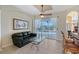 Gathering room features a glass-top coffee table and sliding doors to the pool at 146 Willow Bend Way, Osprey, FL 34229