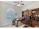 Home office with built-in shelving and wood desk at 146 Willow Bend Way, Osprey, FL 34229