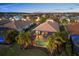 A stunning aerial view of a luxurious home with screened-in pool, surrounded by lush landscaping and greenery at 15326 Castle Park Ter, Lakewood Ranch, FL 34202