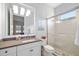 Bright bathroom featuring a double-sink vanity, framed mirror and a shower with glass doors in a contemporary design at 15326 Castle Park Ter, Lakewood Ranch, FL 34202