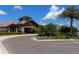 Inviting clubhouse exterior with stone accents, a tile roof, manicured landscaping, and a circular driveway at 15326 Castle Park Ter, Lakewood Ranch, FL 34202