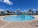 Fun community pool area featuring kid-friendly splash zone, palm trees, and lounge seating at 15326 Castle Park Ter, Lakewood Ranch, FL 34202