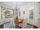 Elegant dining area with a chandelier and a large window showing the lanai and waterfront view at 15326 Castle Park Ter, Lakewood Ranch, FL 34202