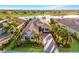 A gorgeous home on the water featuring lush landscaping, a paver driveway and barrel tile roof at 15326 Castle Park Ter, Lakewood Ranch, FL 34202