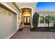 Elegant front entrance with a double door entry, neat landscaping, and a paver walkway at 15326 Castle Park Ter, Lakewood Ranch, FL 34202