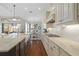 Modern kitchen featuring granite countertops, stainless steel appliances, and an island overlooking the dining area at 15326 Castle Park Ter, Lakewood Ranch, FL 34202