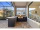 Outdoor kitchen featuring a built-in grill, countertop, bar seating, and window with view to adjacent room at 15326 Castle Park Ter, Lakewood Ranch, FL 34202