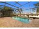 Screened pool area showcasing a shimmering pool, serene lake views, and palm tree accents at 15326 Castle Park Ter, Lakewood Ranch, FL 34202