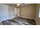 Bedroom with wood-look floors and access to closet and bathroom at 1535 Nursery Rd # 107, Clearwater, FL 33756