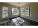 Sunlit dining area with large windows and wood-look floors at 1535 Nursery Rd # 107, Clearwater, FL 33756