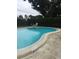 Community pool with surrounding patio area at 1535 Nursery Rd # 107, Clearwater, FL 33756