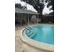 Inviting community pool with steps and lounge chairs at 1535 Nursery Rd # 107, Clearwater, FL 33756