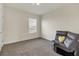 Relaxing bedroom with a recliner and large window, offering ample natural light at 17209 Barnwood Pl, Bradenton, FL 34211