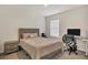 Cozy bedroom with a queen bed, built-in desk and chair, and neutral decor at 17209 Barnwood Pl, Bradenton, FL 34211