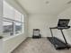 Home office or gym with treadmill, window, and neutral wall paint at 17209 Barnwood Pl, Bradenton, FL 34211