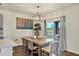 Dining area with wood table, gray chairs, and patio access at 17209 Barnwood Pl, Bradenton, FL 34211