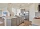 Kitchen island with sink, gray cabinets, and hardwood floor at 17209 Barnwood Pl, Bradenton, FL 34211