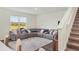 Living room with sectional sofa and large window at 17209 Barnwood Pl, Bradenton, FL 34211