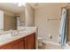 Neutral tiled bathroom featuring a light vanity with marble counters and a shower-tub combo at 17278 Acapulco Rd # 312, Punta Gorda, FL 33955