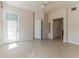 Neutral bedroom featuring tile flooring, with a door to the balcony and a double door closet at 17278 Acapulco Rd # 312, Punta Gorda, FL 33955