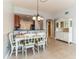 Bright dining room with tile floors, a white table and views of the kitchen at 17278 Acapulco Rd # 312, Punta Gorda, FL 33955