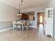 Bright dining room with tile floors, a white table and views of the kitchen at 17278 Acapulco Rd # 312, Punta Gorda, FL 33955