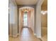 Foyer with tile flooring, chandelier, and transom window over front door at 17278 Acapulco Rd # 312, Punta Gorda, FL 33955