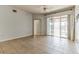 Bright living room featuring tile flooring, sliding glass doors to a balcony, and neutral walls at 17278 Acapulco Rd # 312, Punta Gorda, FL 33955