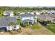 Aerial view of the home's back exterior showcasing the yard, screened in patio and well-maintained lawn at 17395 Palmetto Pass Ln, Punta Gorda, FL 33982