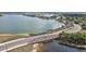 Stunning aerial view of the community's bridge over a lake and adjacent road at 17395 Palmetto Pass Ln, Punta Gorda, FL 33982