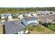 An aerial view of the back of the home highlighting a screened lanai and mature landscaping at 17395 Palmetto Pass Ln, Punta Gorda, FL 33982