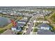 Aerial view of the home's back exterior, including the screen enclosed lanai and neighborhood at 17395 Palmetto Pass Ln, Punta Gorda, FL 33982