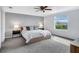 Modern bedroom featuring a large window and gray carpet at 17395 Palmetto Pass Ln, Punta Gorda, FL 33982