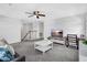 Cozy living room featuring a ceiling fan and gray carpet at 17395 Palmetto Pass Ln, Punta Gorda, FL 33982