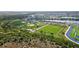 An aerial shot of baseball and soccer fields near a lake in a Gathering-friendly community at 17395 Palmetto Pass Ln, Punta Gorda, FL 33982