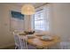 Bright dining room with a wooden table and white chairs at 1752 Banyan Dr, Venice, FL 34293