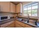 Kitchen corner with microwave and double sink at 1752 Banyan Dr, Venice, FL 34293