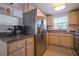 Kitchen with stainless steel fridge and light wood cabinets at 1752 Banyan Dr, Venice, FL 34293