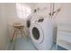 Bright laundry room with washer, dryer, and shelving at 1752 Banyan Dr, Venice, FL 34293