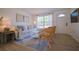 Living room with light colored sofa and rattan chairs at 1752 Banyan Dr, Venice, FL 34293