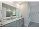 Elegant bathroom with dual sinks, granite countertop, and a large mirror at 17723 Gulf Ranch Pl, Lakewood Ranch, FL 34211